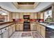 Kitchen with wood cabinets, stainless appliances, and tile flooring at 4501 Keene Rd, Plant City, FL 33565
