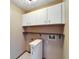 Small laundry room with storage cabinets and connections at 4501 Keene Rd, Plant City, FL 33565