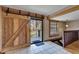 Open living area featuring a barn door entrance to an outside deck at 4501 Keene Rd, Plant City, FL 33565