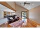 Open-concept living room with vaulted ceilings, a brick fireplace, and hardwood floors at 4501 Keene Rd, Plant City, FL 33565