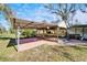 A covered outdoor pavilion with tiled flooring, perfect for entertaining or relaxing in the backyard at 4501 Keene Rd, Plant City, FL 33565