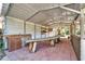 Covered outdoor pavilion with a wooden table and sink, perfect for gatherings or outdoor cooking at 4501 Keene Rd, Plant City, FL 33565