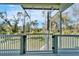Screened porch with white railing overlooking lush greenery at 4501 Keene Rd, Plant City, FL 33565