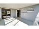 An outdoor porch with gray floors, decorated with cute wall decorations and an outdoor entry to the house at 4501 Keene Rd, Plant City, FL 33565