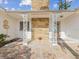 Front entry with stonework, ornate columns, and tile flooring at 529 80Th Ave, St Pete Beach, FL 33706