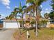 Single-story home with white exterior, attached garage, and landscaping at 529 80Th Ave, St Pete Beach, FL 33706