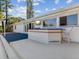 Outdoor kitchen and bar with seating for entertaining at 529 80Th Ave, St Pete Beach, FL 33706