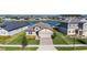 Property view showcasing the house's location by a lake and other houses at 7122 Heron Walk Ln, Wesley Chapel, FL 33545