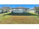 House with covered patio and grassy backyard at 7122 Heron Walk Ln, Wesley Chapel, FL 33545