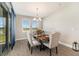 Elegant dining room featuring a rustic wood table and stylish upholstered chairs, perfect for gatherings at 7122 Heron Walk Ln, Wesley Chapel, FL 33545
