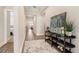 Inviting entryway with wood-look floors and stylish console table that enhances the home's appeal at 7122 Heron Walk Ln, Wesley Chapel, FL 33545