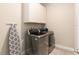 Laundry room with washer, dryer, and white cabinets at 7122 Heron Walk Ln, Wesley Chapel, FL 33545