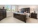 Comfortable primary bedroom with a dark wood furniture set and plush bedding at 7122 Heron Walk Ln, Wesley Chapel, FL 33545