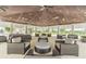 Expansive covered outdoor lounge area with comfortable seating and multiple ceiling fans for relaxation and socializing at 7122 Heron Walk Ln, Wesley Chapel, FL 33545