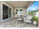 Covered patio with stylish seating and plants, ideal for outdoor relaxation at 7122 Heron Walk Ln, Wesley Chapel, FL 33545