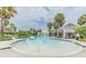 Community pool featuring water features and an adjacent covered seating area near other common community buildings at 7122 Heron Walk Ln, Wesley Chapel, FL 33545