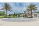 Community splash pad featuring multiple water spouts and decorative palm trees near a covered pavilion at 7122 Heron Walk Ln, Wesley Chapel, FL 33545