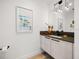 Modern half bathroom with sleek vanity, minimalist decor, and a charming nautical-themed artwork at 100 1St N Ave # 1601, St Petersburg, FL 33701