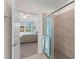 Spa-like bathroom with a large shower and view into bedroom at 10043 Crooked Creek Dr # 101, Venice, FL 34293