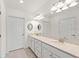Double vanity bathroom with elegant mirrors and neutral tones at 10043 Crooked Creek Dr # 101, Venice, FL 34293