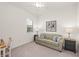 Cozy bedroom with a sofa and large window at 10043 Crooked Creek Dr # 101, Venice, FL 34293