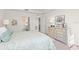 Spacious bedroom with dresser and ensuite bathroom access at 10043 Crooked Creek Dr # 101, Venice, FL 34293