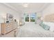 Bright bedroom with large windows, dresser, and ceiling fan at 10043 Crooked Creek Dr # 101, Venice, FL 34293