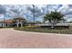 Grand entrance to Sarasota National, featuring a brick paver road at 10043 Crooked Creek Dr # 101, Venice, FL 34293