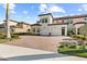 Two-story townhome with a brick driveway and palm trees at 10043 Crooked Creek Dr # 101, Venice, FL 34293