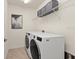 Laundry room with washer and dryer and overhead shelving at 10043 Crooked Creek Dr # 101, Venice, FL 34293