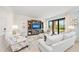 Bright and airy living room with comfy seating and large TV at 10043 Crooked Creek Dr # 101, Venice, FL 34293