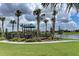 playground with play structures and a nearby lake at 10043 Crooked Creek Dr # 101, Venice, FL 34293