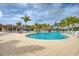 Stunning resort-style pool surrounded by lush landscaping at 10043 Crooked Creek Dr # 101, Venice, FL 34293