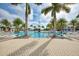 Relaxing resort-style pool with lounge chairs and palm trees at 10043 Crooked Creek Dr # 101, Venice, FL 34293