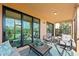 Relaxing screened lanai with comfy seating and view of lush landscaping at 10043 Crooked Creek Dr # 101, Venice, FL 34293