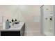 Clean bathroom with dark vanity, double sinks, and a shower at 10911 Gentle Current Way, Parrish, FL 34219