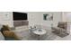 Living room features neutral decor, comfortable seating, and a large TV at 10911 Gentle Current Way, Parrish, FL 34219