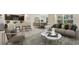 Open living room with comfortable seating, coffee tables, and views to the kitchen and dining area at 10911 Gentle Current Way, Parrish, FL 34219