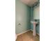 Clean bathroom with pedestal sink and tile floor at 11309 Outrigger Ave, Spring Hill, FL 34608