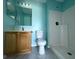 Bathroom with wood vanity, shower, and light walls at 11309 Outrigger Ave, Spring Hill, FL 34608