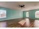 Bright bedroom with hardwood floors and ceiling fan at 11309 Outrigger Ave, Spring Hill, FL 34608
