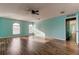 Large bedroom featuring hardwood floors and arched windows at 11309 Outrigger Ave, Spring Hill, FL 34608