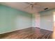 Light and airy bedroom with ceiling fan and hardwood floors at 11309 Outrigger Ave, Spring Hill, FL 34608