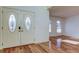 Bright and airy entryway with hardwood floors and stained glass accents at 11309 Outrigger Ave, Spring Hill, FL 34608
