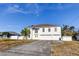 Two-story house with a large driveway and white vinyl siding at 11309 Outrigger Ave, Spring Hill, FL 34608