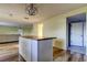 Kitchen with island, white cabinets, and wood countertops at 11309 Outrigger Ave, Spring Hill, FL 34608