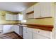 White kitchen cabinets and wood countertops, featuring a window at 11309 Outrigger Ave, Spring Hill, FL 34608