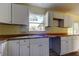 Kitchen features white cabinets, wood countertops, and a sink at 11309 Outrigger Ave, Spring Hill, FL 34608