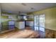 Modern kitchen with white cabinets, an island, and hardwood floors at 11309 Outrigger Ave, Spring Hill, FL 34608