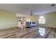 Spacious living room with hardwood floors and a view into the kitchen at 11309 Outrigger Ave, Spring Hill, FL 34608